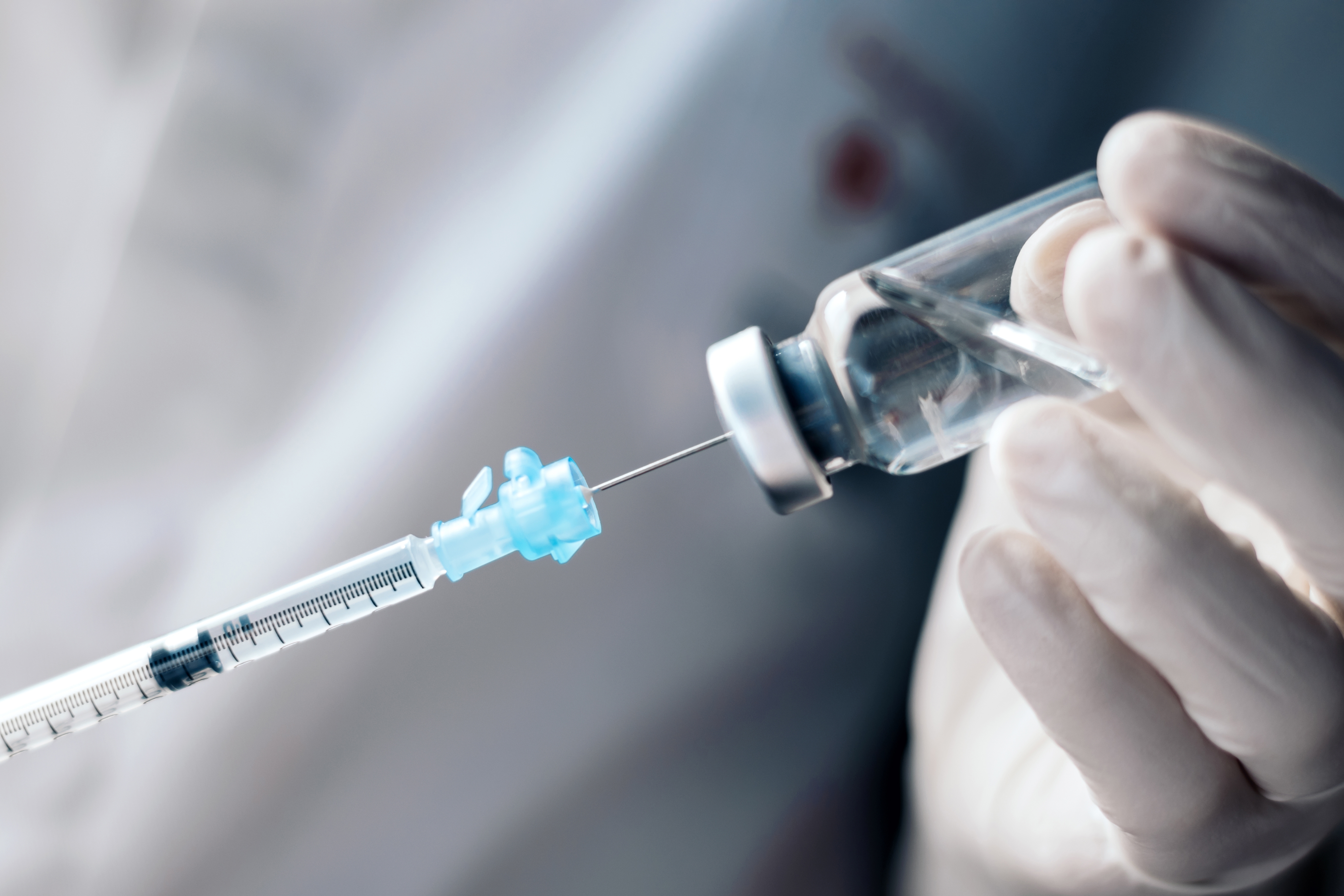 Injecting,Injection,Vaccine,Vaccination,Medicine,Into,A,Syringe,Woman,Nurse